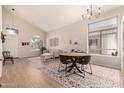 Bright living room with hardwood floors, a cozy sofa, and vaulted ceilings at 4702 N 124Th Ave, Avondale, AZ 85392