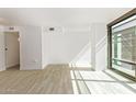 Open living space with light tile flooring and large windows at 4808 N 24Th St # 230, Phoenix, AZ 85016