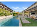 Beautiful backyard oasis with a pool, pergola, patio, and pavers surrounded by desert landscaping, ideal for entertaining at 5420 E Duane Ln, Cave Creek, AZ 85331