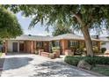 Attractive brick home featuring a well-maintained yard and a covered carport at 5808 N 18Th Pl, Phoenix, AZ 85016