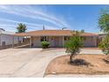 Single-level home featuring a covered carport and circular driveway with low maintenance landscaping at 6126 N 31St Dr, Phoenix, AZ 85017
