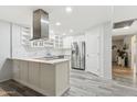 Bright kitchen with modern island, stainless steel appliances, and ample cabinet space at 614 N Pioneer Cir, Mesa, AZ 85203