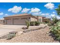 Charming single-story home with tile roof and well-maintained desert landscaping with decorative rocks at 6162 E Redmont Dr, Mesa, AZ 85215