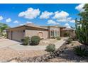 Inviting single-story house with desert landscaping, well-maintained exterior, and brick-accented archway at 6162 E Redmont Dr, Mesa, AZ 85215