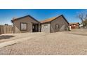 Inviting single-story home with desert landscaping and a pathway to the front door at 7506 W Sells Dr, Phoenix, AZ 85033