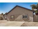 Side view of single story house with desert landscaping and paved driveway at 7506 W Sells Dr, Phoenix, AZ 85033