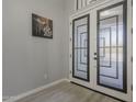 Bright foyer with decorative glass double doors and light hardwood floors at 797 E Cedar Dr, Chandler, AZ 85249