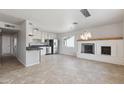 Modern kitchen featuring stainless steel appliances, granite countertops, white cabinetry and a view to the living room at 8301 E Indianola Ave, Scottsdale, AZ 85251