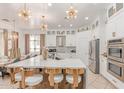 Modern kitchen with a large island, stainless steel appliances, and stylish lighting fixtures at 84 E Joseph Way, Gilbert, AZ 85295