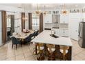 Bright open kitchen with island, marble countertops, stainless steel appliances, modern lighting, and breakfast nook at 84 E Joseph Way, Gilbert, AZ 85295