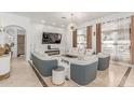 Stylish living room with a fireplace, mounted TV, elegant sofas, and modern decor at 84 E Joseph Way, Gilbert, AZ 85295
