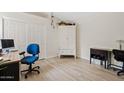 Bright bedroom with a large closet, wood-look floors, and a versatile workspace with a modern desk at 912 W Sunward Dr, Gilbert, AZ 85233