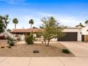 Beautiful single-story home featuring a landscaped front yard with desert accents at 9637 E Gold Dust Ave, Scottsdale, AZ 85258