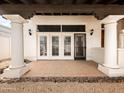 Covered patio with tile flooring, columns, and french doors for outdoor enjoyment at 9637 E Gold Dust Ave, Scottsdale, AZ 85258
