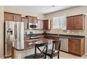 A kitchen featuring stainless steel appliances, a kitchen island with dark wood cabinets at 11048 E Quintana Ave, Mesa, AZ 85212