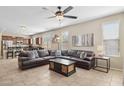 Spacious living room with a large sectional sofa, a ceiling fan, and tile floors at 11048 E Quintana Ave, Mesa, AZ 85212