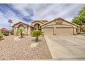 Attractive beige home with xeriscape landscaping and a spacious three-car garage at 1217 S Longmore Ct, Chandler, AZ 85286