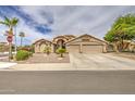 Beautiful beige home featuring desert landscaping and a large driveway at 1217 S Longmore Ct, Chandler, AZ 85286