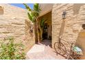 Charming courtyard entrance with desert landscaping, a decorative bicycle, and a welcoming atmosphere at 1235 N Sunnyvale -- # 113, Mesa, AZ 85205