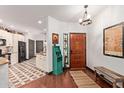 Welcoming foyer with wood flooring, a decorative rug, and a view into the kitchen at 1235 N Sunnyvale -- # 113, Mesa, AZ 85205