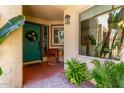 Inviting front porch with a decorative door, plants, a chair, and a cozy ambiance at 1235 N Sunnyvale -- # 113, Mesa, AZ 85205