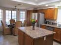 Well-lit kitchen featuring granite countertops, stainless steel appliances, and ample cabinet space at 1819 E Sheena Dr, Phoenix, AZ 85022