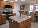 Bright kitchen with a granite island, stainless steel appliances, and plenty of natural light at 1819 E Sheena Dr, Phoenix, AZ 85022