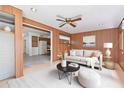 Cozy living room with wood paneling, a comfortable sofa, and an open doorway to the kitchen, creating a warm atmosphere at 2145 W Cholla St, Phoenix, AZ 85029