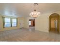 Inviting living room with a chandelier, tile entry, and an open floor plan at 3665 E Thames Way, San Tan Valley, AZ 85140