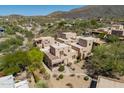Stunning aerial view of a property surrounded by lush greenery and mountain vistas at 38065 N Cave Creek Rd # 52, Cave Creek, AZ 85331