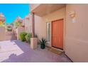 Inviting entryway with vibrant front door, lush plants, and a welcoming doormat at 38065 N Cave Creek Rd # 52, Cave Creek, AZ 85331