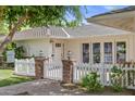 Charming front exterior featuring a white picket fence, brick accents, and a well-manicured lawn at 3817 E Highland Ave, Phoenix, AZ 85018
