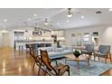 Open-concept living room with hardwood floors, modern furnishings, and a seamless flow to the kitchen at 3817 E Highland Ave, Phoenix, AZ 85018