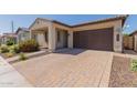 Beautiful home exterior featuring a brick driveway, a two-car garage, and a well maintained front yard at 3892 E Harrison St, Gilbert, AZ 85295