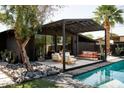 Private backyard oasis with a covered patio, comfortable seating, and a sparkling pool at 4032 N 45Th Pl, Phoenix, AZ 85018