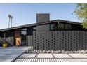 Contemporary home with unique architectural details, wood door, modern brickwork, and landscaped front yard at 4032 N 45Th Pl, Phoenix, AZ 85018