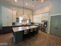 Spacious kitchen features a large island with seating, modern appliances, and stylish pendant lighting at 4132 N 42Nd St, Phoenix, AZ 85018