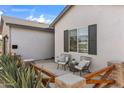 Side patio area features seating, stylish decor, and a well-maintained yard at 4132 N 42Nd St, Phoenix, AZ 85018