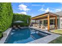 Backyard featuring a private pool, covered patio, and lush greenery at 4132 N 42Nd St, Phoenix, AZ 85018