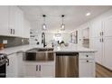 Bright, remodeled kitchen features stainless appliances, white cabinets, quartz countertop island, and modern fixtures at 4234 E Winnetka Dr, Phoenix, AZ 85044