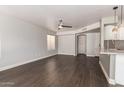 Open living space with a ceiling fan, wood floors, and views into the kitchen at 4434 E Bannock St, Phoenix, AZ 85044