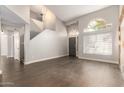 Spacious living room with dark wood floors, light gray walls, and large windows for natural light at 4434 E Bannock St, Phoenix, AZ 85044