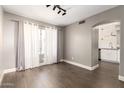 Cozy living room showcasing wood floors, neutral decor, and an open archway leading to the kitchen at 4434 E Bannock St, Phoenix, AZ 85044