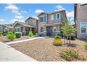 Charming two-story home featuring neutral paint, desert landscaping, and inviting front porch entry at 5741 W Warner St, Phoenix, AZ 85043