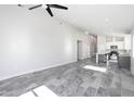 Spacious living room featuring gray tile floors, recessed lighting, and an open concept design at 9310 W Washington St, Tolleson, AZ 85353