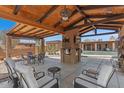 Outdoor patio area with seating, a brick fireplace, and views of the pool at 9607 E Mckellips Rd, Mesa, AZ 85207