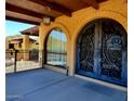 Inviting covered entrance with arched door and window at 9607 E Mckellips Rd, Mesa, AZ 85207