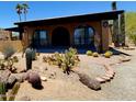 Inviting home exterior with desert landscaping, arched windows, and ample curb appeal at 9607 E Mckellips Rd, Mesa, AZ 85207