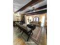 Bright, open living area features exposed wood beams, neutral color palette, and decorative chandeliers at 9607 E Mckellips Rd, Mesa, AZ 85207