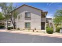 Charming two-story apartment exterior with well-maintained landscaping, stairs to a covered balcony, and a serene atmosphere at 9750 N Monterey Dr # 71, Fountain Hills, AZ 85268